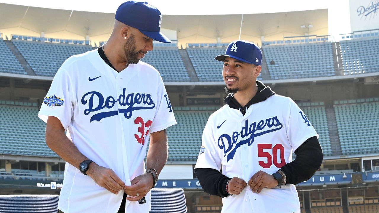 LOS ANGELES, CA - FEBRUARY 12: Los Angeles Dodgers Mookie Betts #50 and David Price #33 adjust their jerseys as they are introduced at a press conference at Dodger Stadium on February 12, 2020 in Los Angeles, California.