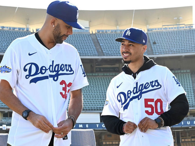 LOS ANGELES, CA - FEBRUARY 12: Los Angeles Dodgers Mookie Betts #50 and David Price #33 adjust their jerseys as they are introduced at a press conference at Dodger Stadium on February 12, 2020 in Los Angeles, California.