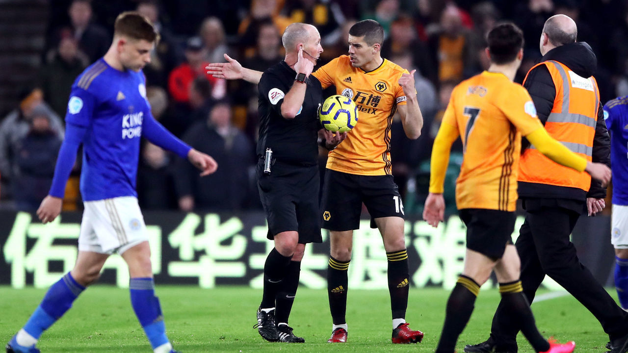 Wolverhampton Wanderers' Conor Coady speaks to referee Mike Dean at half time of the Premier League match at Molineux, Wolverhampton.