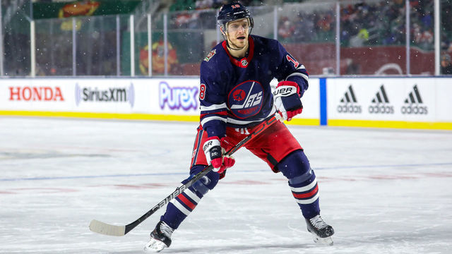 REGINA, SK - OCTOBER 26: Bryan Little #18 of the Winnipeg Jets keeps an eye on the play during third period action against the Calgary Flames during the 2019 Tim Hortons NHL Heritage Classic at Mosaic Stadium on October 26, 2019 in Regina, Saskatchewan, Canada. The Jets defeated the Flames 2-1 in overtime.