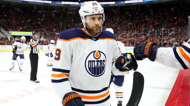 RALEIGH, NC - FEBRUARY 16: Leon Draisaitl #29 of the Edmonton Oilers scores a goal and skates back to the bench to celebrate with teammates during an NHL game against the Carolina Hurricanes on February 16, 2020 at PNC Arena in Raleigh, North Carolina.