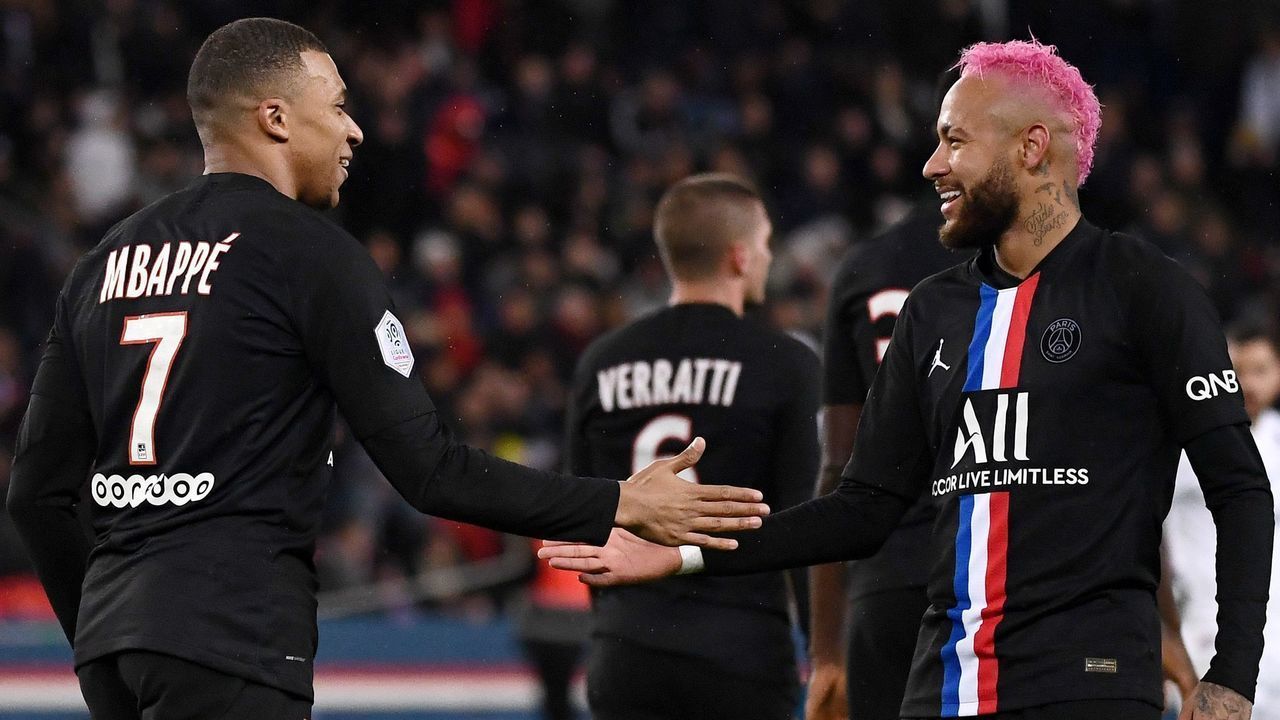 Paris Saint-Germain's French forward Kylian MBappe (L) is congratuled by Paris Saint-Germain's Brazilian forward Neymar after scoring a goal during the French L1 football match between Paris Saint-Germain (PSG) and Montpellier Herault SC at the Parc des Princes stadium in Paris, on February 1, 2020.