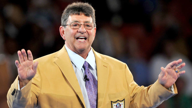 CANTON, OH - AUGUST 4, 2016: 2016 Hall of Fame enshrinee, owner Edward DeBartolo Jr. waves to the crowd after receiving his gold jacket during the Pro Football Hall of Fame Gold Jacket Dinner on August 4, 2016 at the Canton Memorial Civic Center in Canton, Ohio.