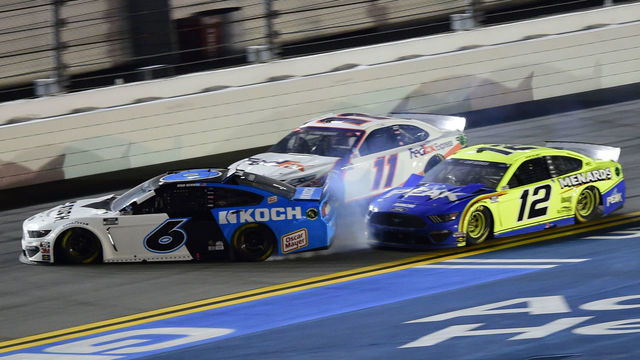 DAYTONA BEACH, FLORIDA - FEBRUARY 17: Denny Hamlin, driver of the #11 FedEx Express Toyota, wins over Ryan Blaney, driver of the #12 Menards/Peak Ford, as Ryan Newman, driver of the #6 Koch Industries Ford, crashes and flips behind them during the NASCAR Cup Series 62nd Annual Daytona 500 at Daytona International Speedway on February 17, 2020 in Daytona Beach, Florida.