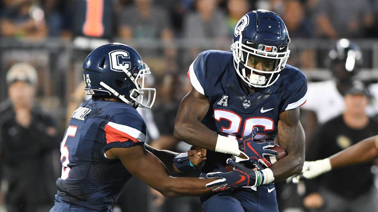 EAST HARTFORD, CT - AUGUST 30: Connecticut Huskies quarterback David Pindell (5) hands the ball off to Connecticut Huskies running back Khyon Gillespie (36) during the game between the UConn Huskies and the UCF Knights on August 30, 2018 at Rentschler Field in East Hartford, CT.