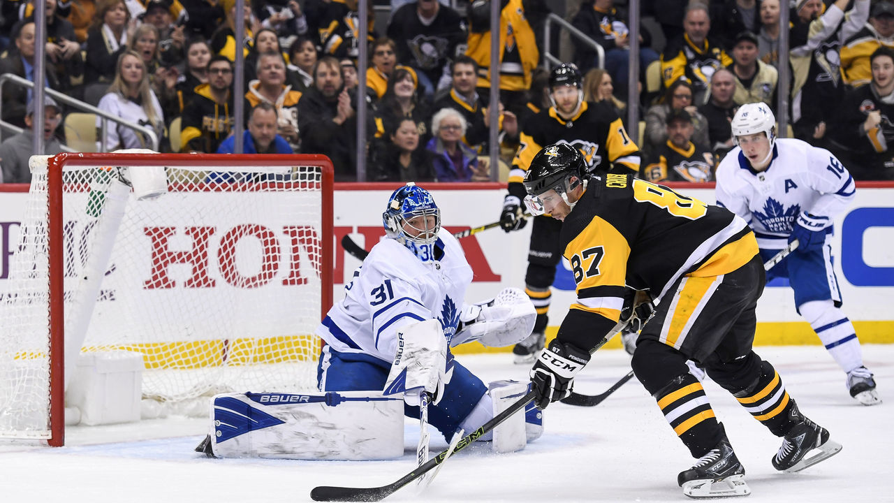 PITTSBURGH, PA - FEBRUARY 18: Pittsburgh Penguins Center Sidney Crosby (87) goes to the net with the puck on Toronto Maple Leafs Goalie Frederik Andersen (31) during the second period in the NHL game between the Pittsburgh Penguins and the Toronto Maple Leafs on February 18, 2020, at PPG Paints Arena in Pittsburgh, PA.