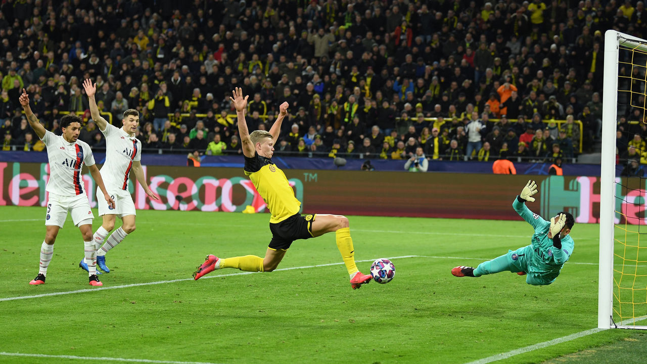 DORTMUND, GERMANY - FEBRUARY 18: Erling Haaland of Borussia Dortmund scores his team's first goal past Keylor Navas of Paris Saint-Germain during the UEFA Champions League round of 16 first leg match between Borussia Dortmund and Paris Saint-Germain at Signal Iduna Park on February 18, 2020 in Dortmund, Germany.
