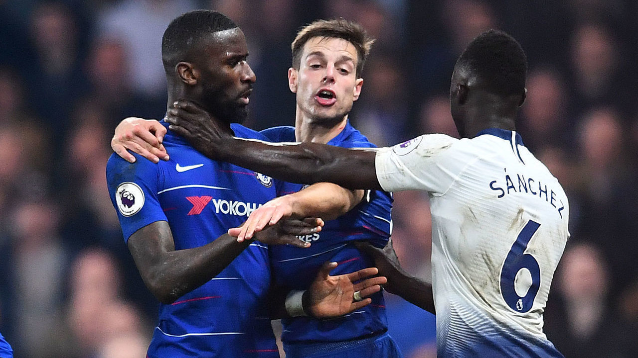 LONDON, ENGLAND - FEBRUARY 27: Cesar Azpilicueta of Chelsea intervenes as Davinson Sanchez of Tottenham Hotspur and Antonio Ruediger of Chelsea clash during the Premier League match between Chelsea FC and Tottenham Hotspur at Stamford Bridge on February 27, 2019 in London, United Kingdom.