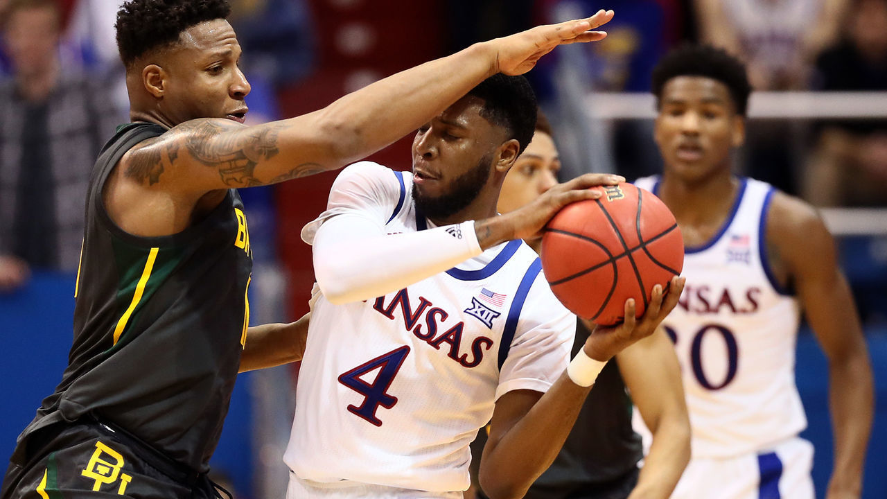 LAWRENCE, KANSAS - JANUARY 11: Isaiah Moss #4 of the Kansas Jayhawks controls the ball as Mark Vital #11 of the Baylor Bears defends during the game at Allen Fieldhouse on January 11, 2020 in Lawrence, Kansas.