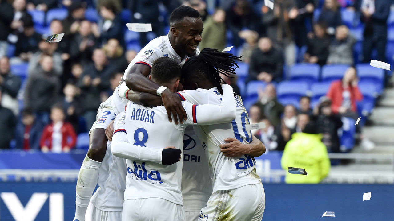 Lyon's players celebrate after Lyon's Burkinabe forward Bertrand Traore (R) scored a goal during the French L1 football match between Lyon (OL) and Strasbourg (RCSA) on February 16, 2020 at the Groupama Stadium in Decines-Charpieu near Lyon, southeastern France.