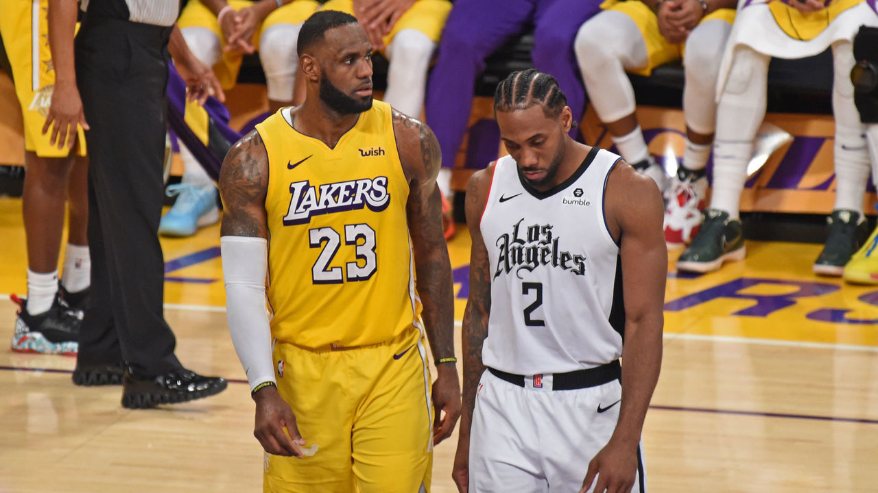 LOS ANGELES, CA - DECEMBER 25: LeBron James #23 of the Los Angeles Lakers and Kawhi Leonard #2 of the LA Clippers look on during the game on December 25, 2019 at STAPLES Center in Los Angeles, California. NOTE TO USER: User expressly acknowledges and agrees that, by downloading and/or using this Photograph, user is consenting to the terms and conditions of the Getty Images License Agreement. Mandatory Copyright Notice: Copyright 2019 NBAE