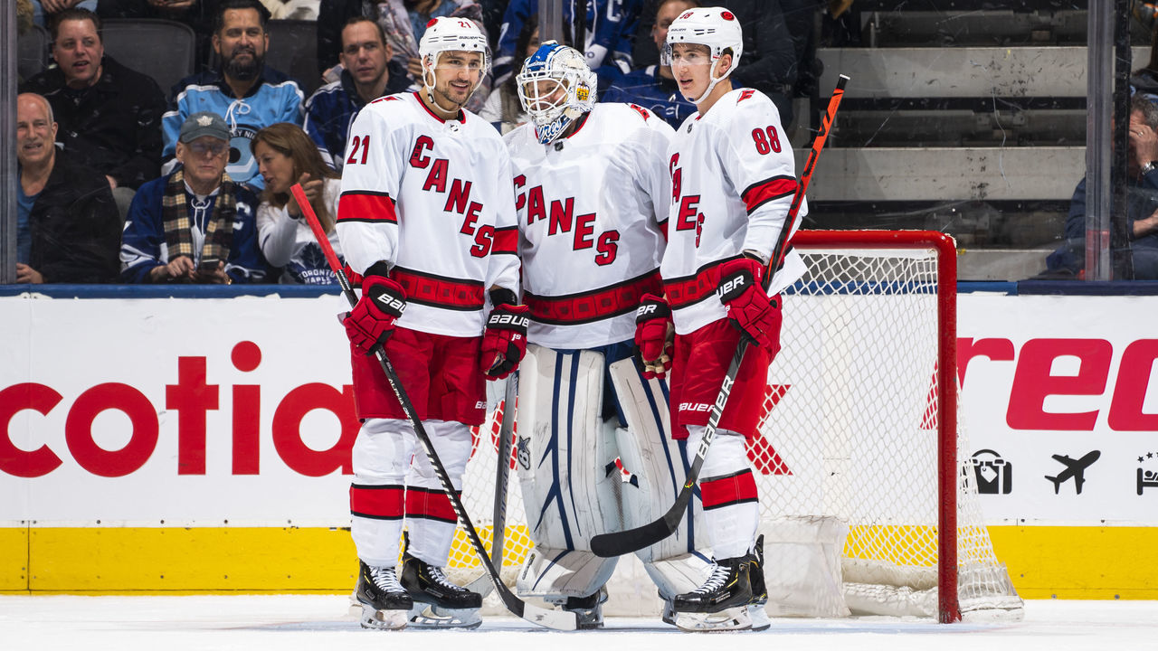 TORONTO, ON - FEBRUARY 22: Nino Niederreiter #21 and Martin Necas #88 of the Carolina Hurricanes talk with emergency backup goaltender Dave Ayres #90 during the second period against the Toronto Maple Leafs at the Scotiabank Arena on February 22, 2020 in Toronto, Ontario, Canada.