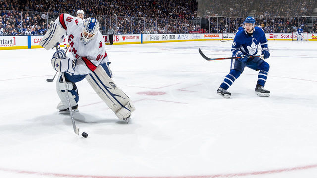 TORONTO, ON - FEBRUARY 22: Dave Ayres #90 of the Caroline Hurricanes plays the puck against Zach Hyman #11 of the Toronto Maple Leafs during the second period at the Scotiabank Arena on February 22, 2020 in Toronto, Ontario, Canada.