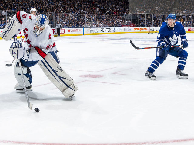 TORONTO, ON - FEBRUARY 22: Dave Ayres #90 of the Caroline Hurricanes plays the puck against Zach Hyman #11 of the Toronto Maple Leafs during the second period at the Scotiabank Arena on February 22, 2020 in Toronto, Ontario, Canada.