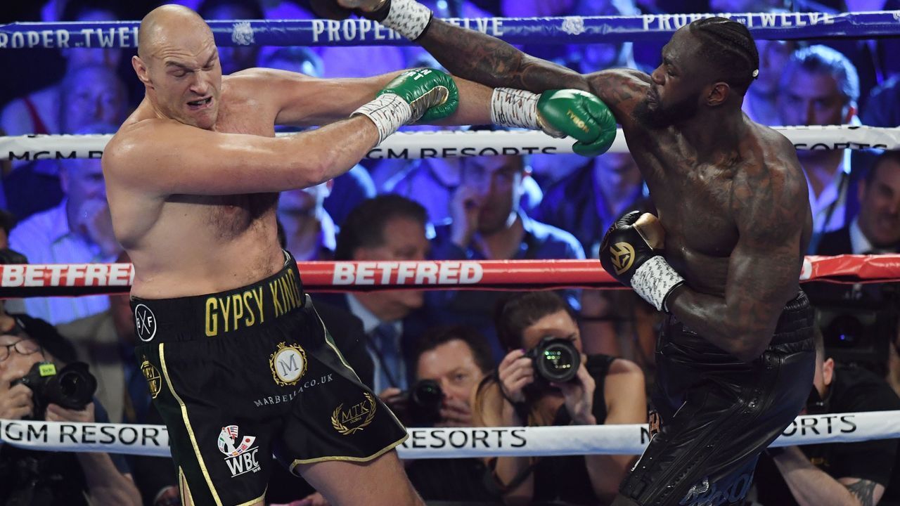 British boxer Tyson Fury (L) and US boxer Deontay Wilder exchange punches during their World Boxing Council (WBC) Heavyweight Championship Title boxing match at the MGM Grand Garden Arena in Las Vegas on February 22, 2020.