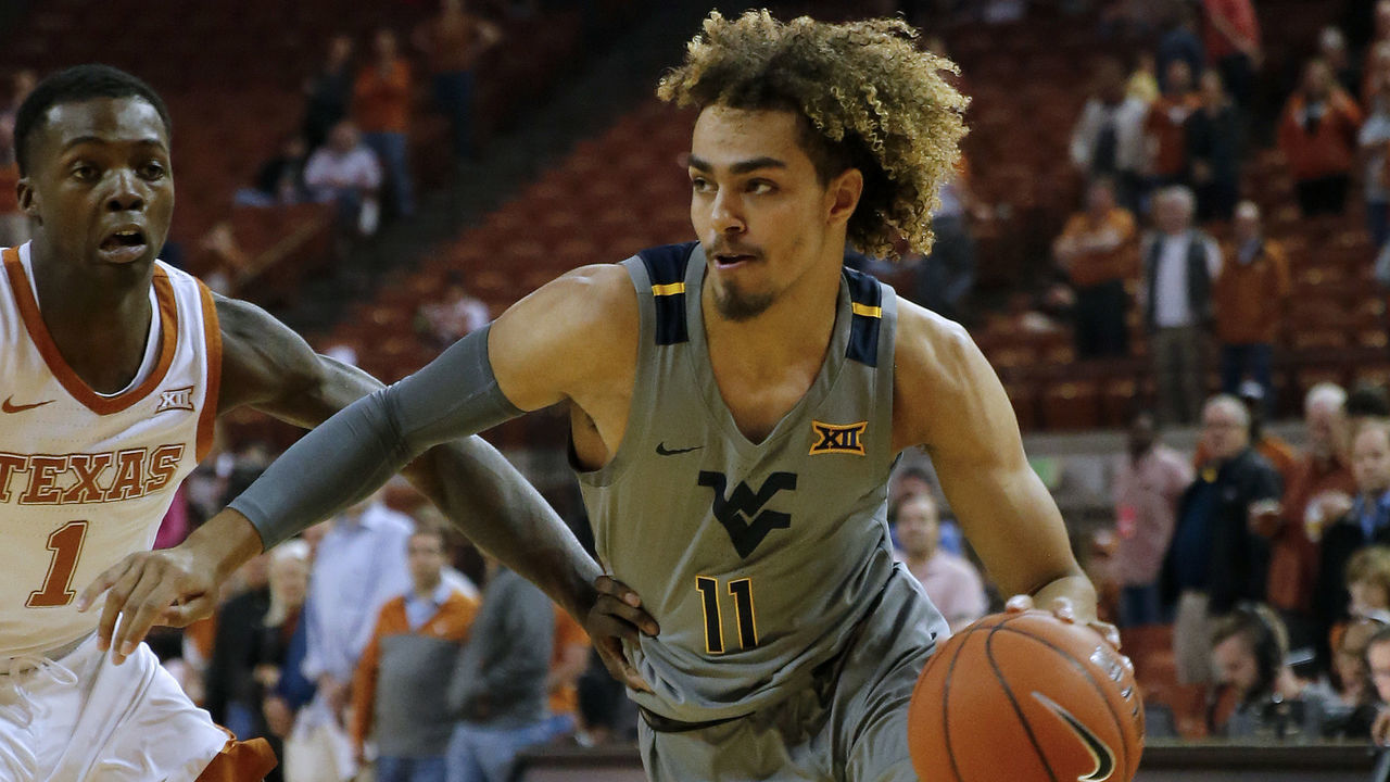 AUSTIN, TEXAS - FEBRUARY 24: Emmitt Matthews Jr. #11 of the West Virginia Mountaineers drives around Andrew Jones #1 of the Texas Longhorns at The Frank Erwin Center on February 24, 2020 in Austin, Texas.