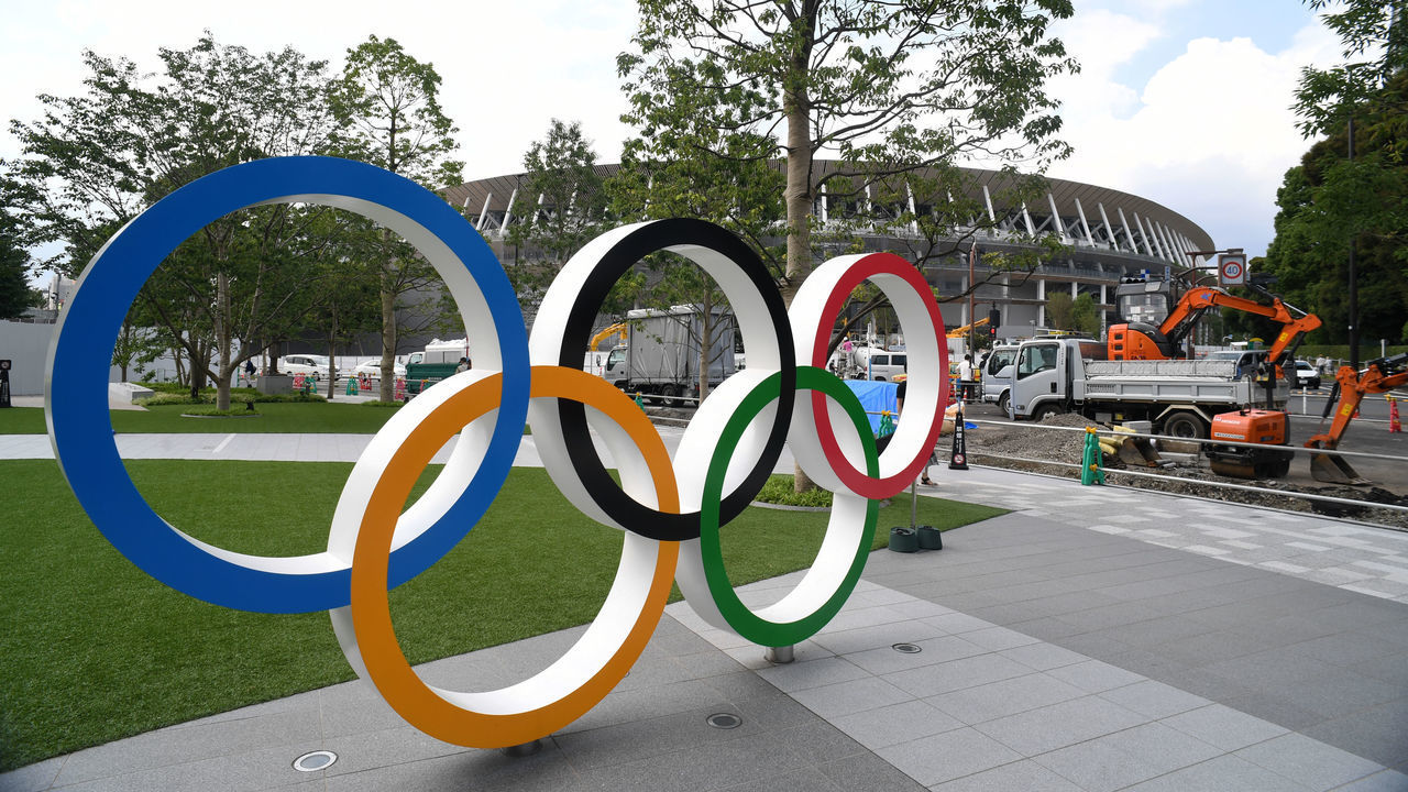 TOKYO, JAPAN - JULY 24: The Olympic Rings are displayed in front of the new national stadiumm which construction continues on the day marking the one year to go to the Tokyo 2020 Olympic Games on July 24, 2019 in Tokyo, Japan.