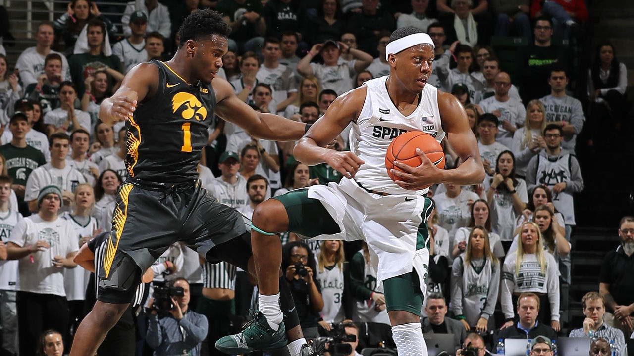 EAST LANSING, MI - FEBRUARY 25: Cassius Winston #5 of the Michigan State Spartans grabs a loose ball in front of Joe Toussaint #1 of the Iowa Hawkeyes in the second half of the game at the Breslin Center on February 25, 2020 in East Lansing, Michigan.