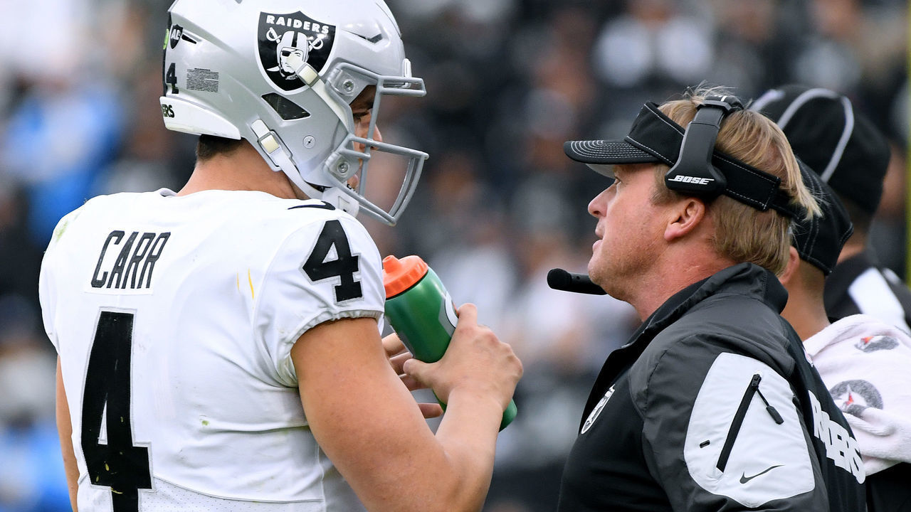 CARSON, CALIFORNIA - DECEMBER 22: Head coach Jon Gruden of the Oakland Raiders speaks to Derek Carr #4 during a 24-17 win over the Los Angeles Chargers at Dignity Health Sports Park on December 22, 2019 in Carson, California.