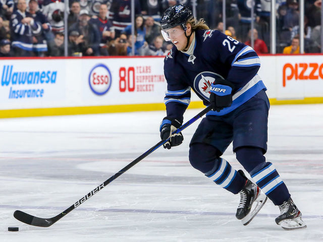 WINNIPEG, MB - FEBRUARY 4: Patrik Laine #29 of the Winnipeg Jets carries the puck down the ice during a second period penalty shot against the Nashville Predators at the Bell MTS Place on February 4, 2020 in Winnipeg, Manitoba, Canada. The Preds defeated the Jets 2-1 in overtime.