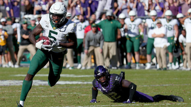 FORT WORTH, TEXAS - NOVEMBER 09: Denzel Mims #5 of the Baylor Bears scores a touchdown against Jeff Gladney #12 of the TCU Horned Frogs in the second overtime period at Amon G. Carter Stadium on November 09, 2019 in Fort Worth, Texas.