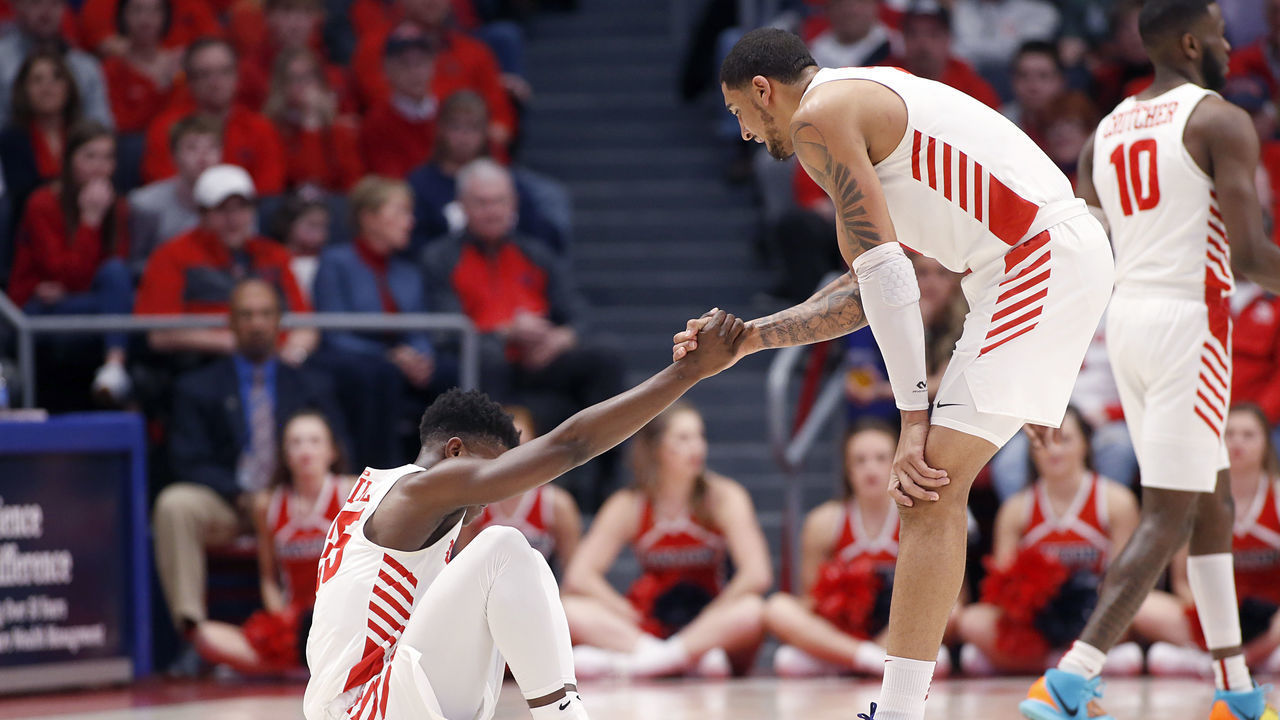 DAYTON, OHIO - FEBRUARY 22: Obi Toppin #1 of the Dayton Flyers helps Dwayne Cohill #35 of the Dayton Flyers up in the game against the Duquesne Dukes at UD Arena on February 22, 2020 in Dayton, Ohio.