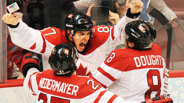 Canadian forward Sidney Crosby (C) celebrates with teammates Scott Niedermayer (L) and Drew Doughty as Canada's team win gold during the Men's Gold Medal Hockey match between USA and Canada at the Canada Hockey Place during the XXI Winter Olympic Games in Vancouver, Canada on February 28, 2010. Canada beat the USA 3-2 to win gold. AFP PHOTO / YURI KADOBNOV