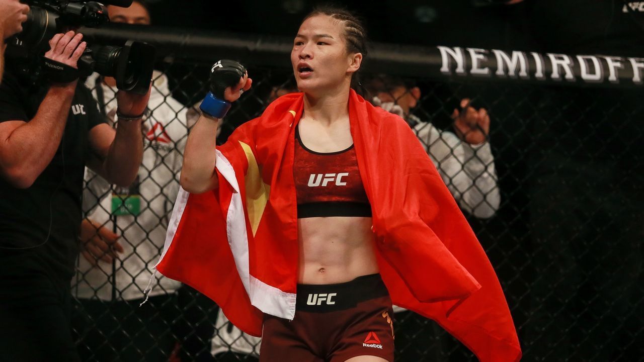 Zhang Weili (C) of China celebrates after defeating Jessica Andrade of Brazil (not pictured) during in their UFC mixed martial arts (MMA) bout in Shenzhen, Guangdong province, on August 31, 2019.