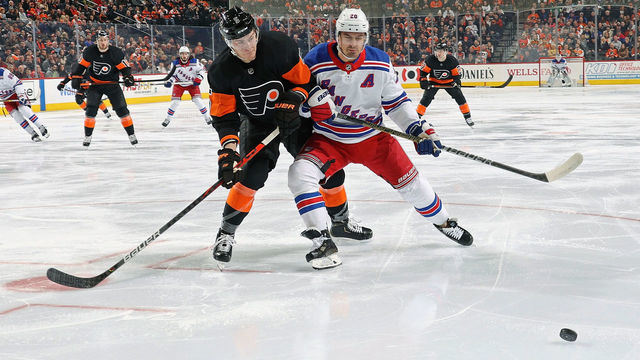 PHILADELPHIA, PA - FEBRUARY 28: Philippe Myers #5 of the Philadelphia Flyers battles for control of the loose puck in the corner with Chris Kreider #20 of the New York Rangers on February 28, 2020 at the Wells Fargo Center in Philadelphia, Pennsylvania.