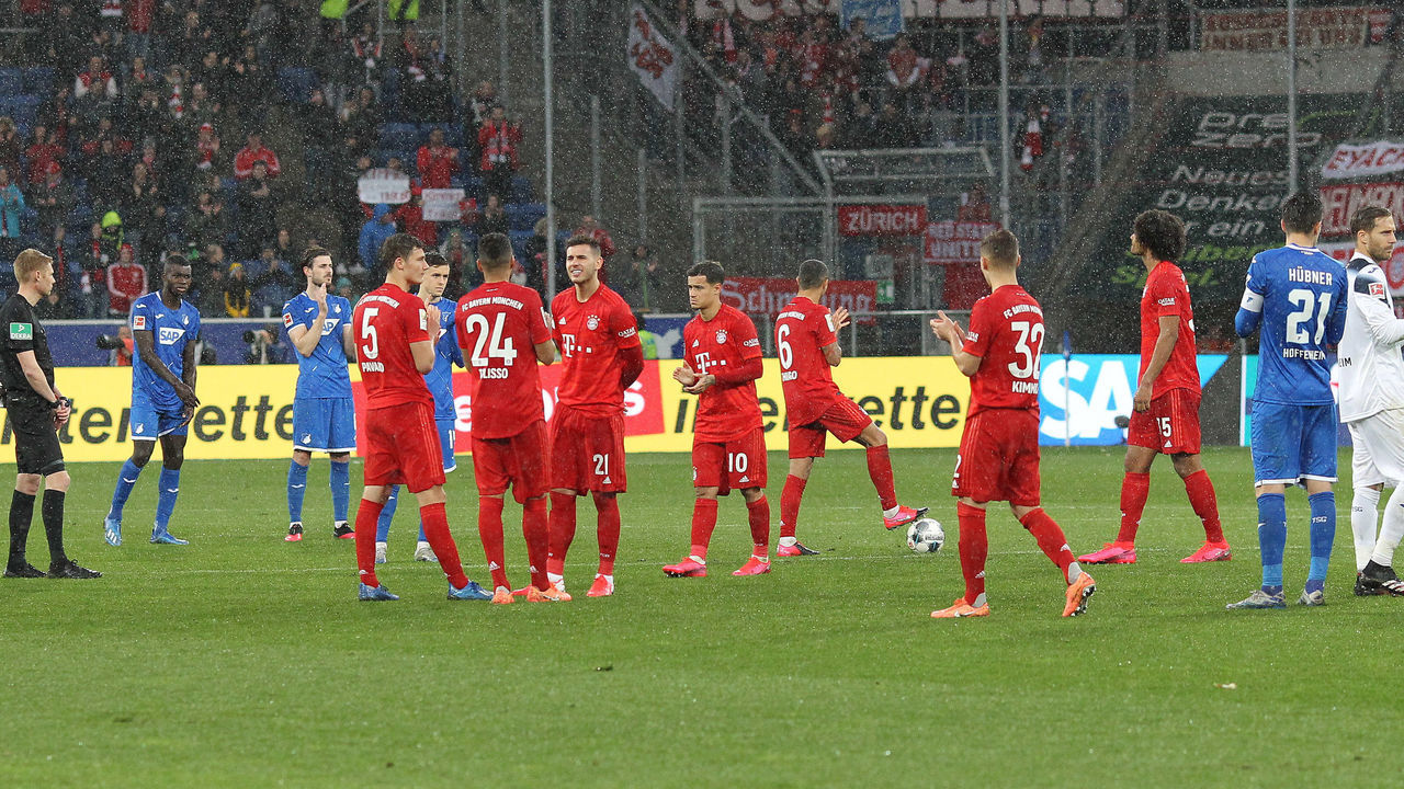 Hoffenheim's and Bayern Munich's players wait for the match to be stopped during the German first division Bundesliga football match Hoffenheim v Bayern Munich on February 29, 2020 in Sinsheim.