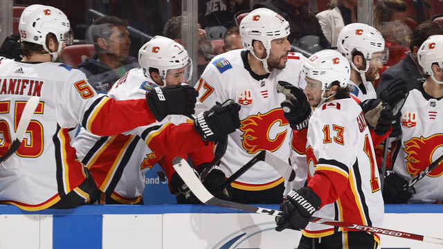 SUNRISE, FL - MARCH 1: Teammates congratulate Johnny Gaudreau #13 of the Calgary Flames after he scored a first period goal against the Florida Panthers at the BB&T Center on March 1, 2020 in Sunrise, Florida.