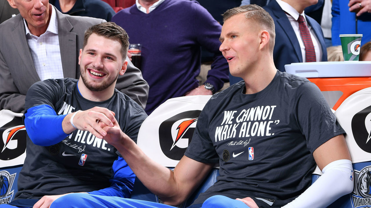 DALLAS, TX - JANUARY 21: Luka Doncic #77 and Kristaps Porzingis #6 of the Dallas Mavericks fist bump before the game against the LA Clippers of the Dallas Mavericks and ; on January 21, 2020 at the American Airlines Center in Dallas, Texas. Mandatory Copyright Notice: Copyright 2020 NBAE
