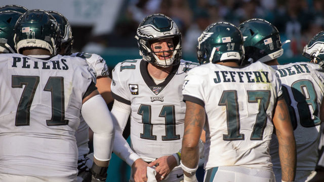 MIAMI GARDENS, FL - DECEMBER 01: Philadelphia Eagles Quarterback Carson Wentz (11) in the huddle with Philadelphia Eagles Offensive Guard Isaac Seumalo (73), Philadelphia Eagles Offensive Tackle Jason Peters (71) and Philadelphia Eagles Wide Receiver Alshon Jeffery (17) during the NFL game between the Philadelphia Eagles and the Miami Dolphins at the Hard Rock Stadium in Miami Gardens, Florida on December 1, 2019.