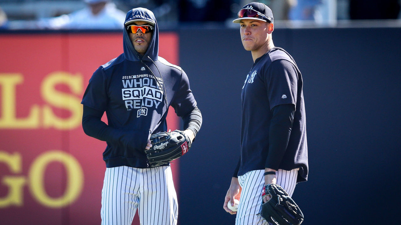 TAMPA, FLORIDA - MARCH 06: Giancarlo Stanton #27 and Aaron Judge #99 of the New York Yankees look on before the Grapefruit League spring training game against the St. Louis Cardinals at Steinbrenner Field on March 06, 2019 in Tampa, Florida.