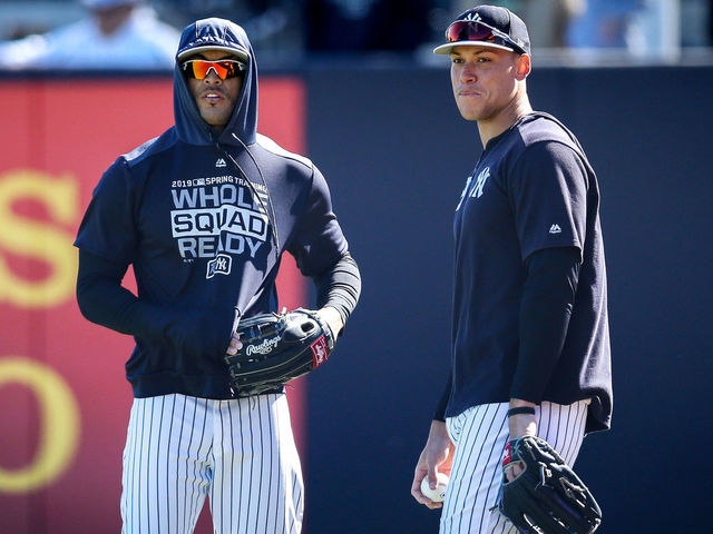 TAMPA, FLORIDA - MARCH 06: Giancarlo Stanton #27 and Aaron Judge #99 of the New York Yankees look on before the Grapefruit League spring training game against the St. Louis Cardinals at Steinbrenner Field on March 06, 2019 in Tampa, Florida.
