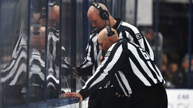 COLUMBUS, OH - APRIL 17: Linesmen Matt MacPherson #83 and Darren Gibbs #66 review an offside challenge during the second period between the Columbus Blue Jackets and the Washington Capitals in Game Three of the Eastern Conference First Round during the 2018 NHL Stanley Cup Playoffs at Nationwide Arena in Columbus, Ohio.