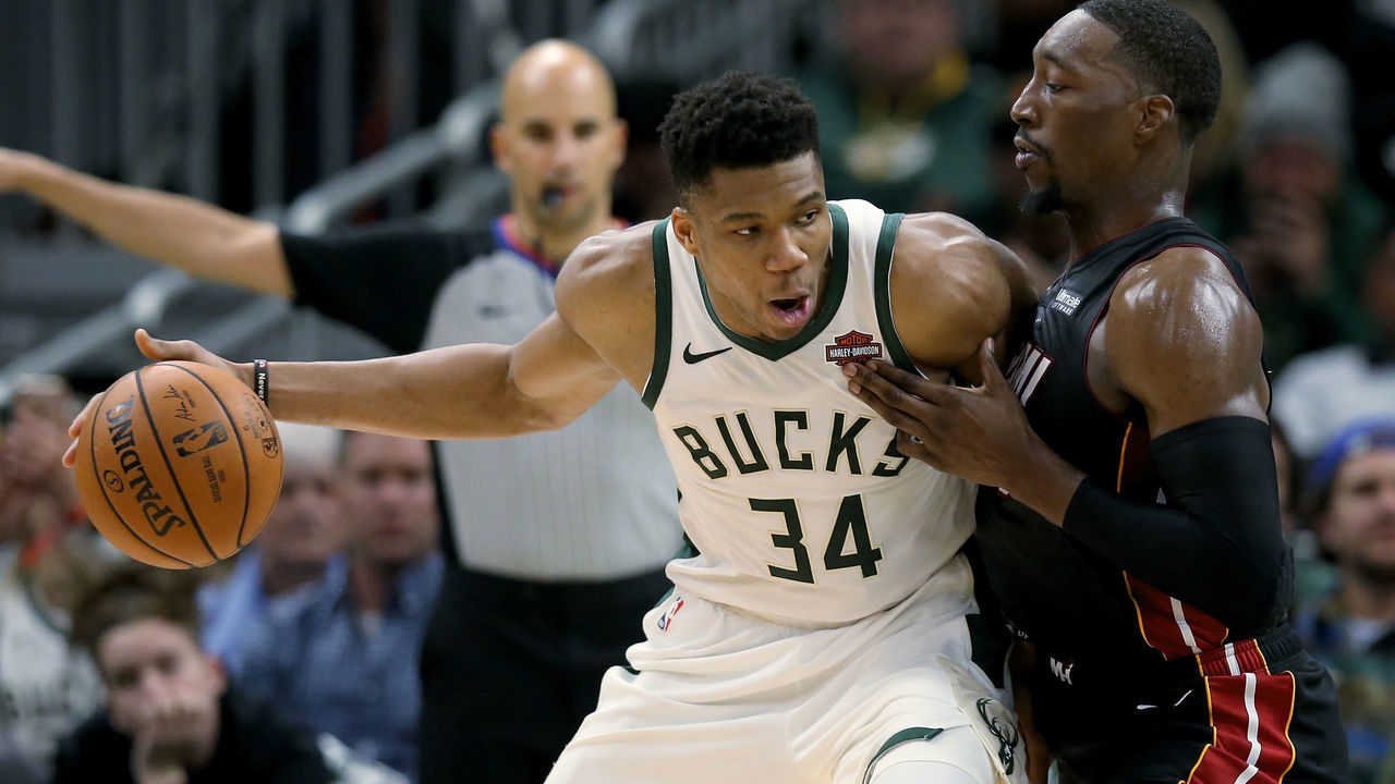 MILWAUKEE, WISCONSIN - OCTOBER 26: Giannis Antetokounmpo #34 of the Milwaukee Bucks dribbles the ball while being guarded by Bam Adebayo #13 of the Miami Heat in the fourth quarter at the Fiserv Forum on October 26, 2019 in Milwaukee, Wisconsin. NOTE TO USER: User expressly acknowledges and agrees that, by downloading and/or using this photograph, user is consenting to the terms and conditions of the Getty Images License Agreement.