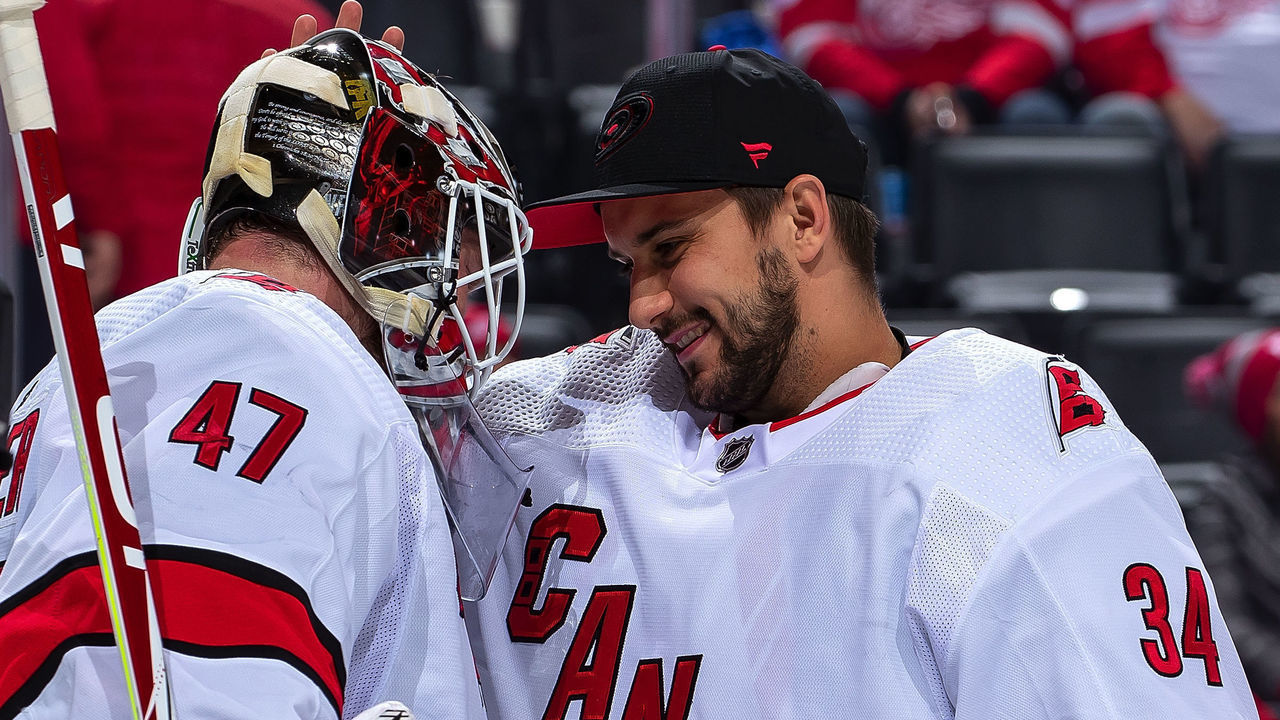 DETROIT, MI - NOVEMBER 24: Petr Mrazek #34 of the Carolina Hurricanes congratulates teammate James Reimer #47 after an NHL game against the Detroit Red Wings at Little Caesars Arena on November 24, 2019 in Detroit, Michigan. Carolina defeated Detroit 2-0.