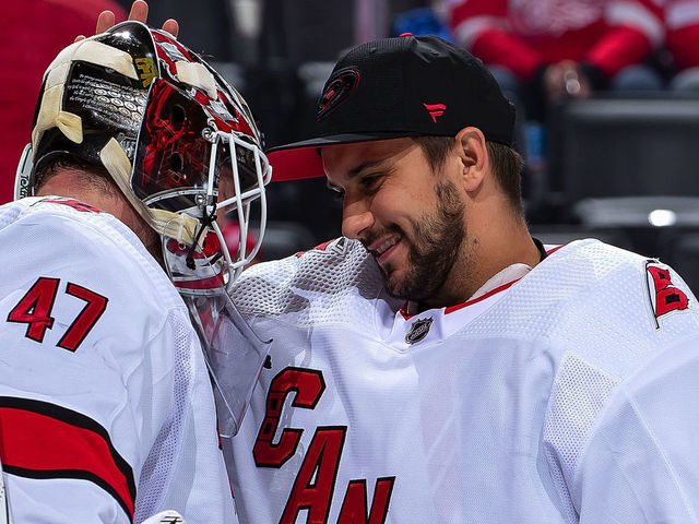 DETROIT, MI - NOVEMBER 24: Petr Mrazek #34 of the Carolina Hurricanes congratulates teammate James Reimer #47 after an NHL game against the Detroit Red Wings at Little Caesars Arena on November 24, 2019 in Detroit, Michigan. Carolina defeated Detroit 2-0.