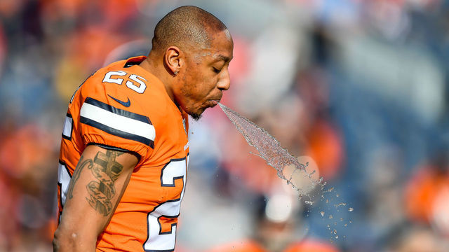 DENVER, CO - DECEMBER 22: Chris Harris #25 of the Denver Broncos spits water as he warms up before a game against the Detroit Lions at Empower Field at Mile High on December 22, 2019 in Denver, Colorado.