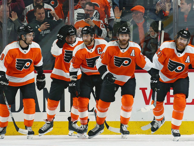 PHILADELPHIA, PA - MARCH 05: Sean Couturier #14 of the Philadelphia Flyers celebrates with Ivan Provorov #9, Matt Niskanen #15, Claude Giroux #28, and Jakub Voracek #93 after scoring a third perido goal against the Carolina Hurricanes on March 5, 2020 at the Wells Fargo Center in Philadelphia, Pennsylvania.