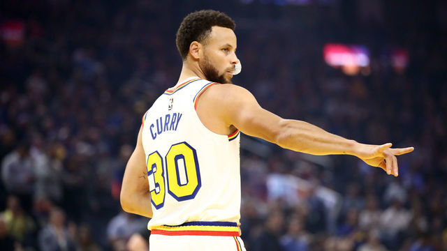 SAN FRANCISCO, CALIFORNIA - MARCH 05: Stephen Curry #30 of the Golden State Warriors motions to the Toronto Raptors bench before their game at Chase Center on March 05, 2020 in San Francisco, California.