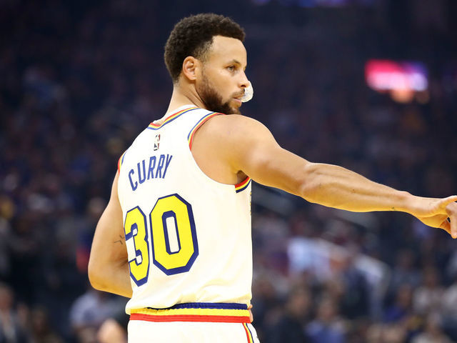 SAN FRANCISCO, CALIFORNIA - MARCH 05: Stephen Curry #30 of the Golden State Warriors motions to the Toronto Raptors bench before their game at Chase Center on March 05, 2020 in San Francisco, California.
