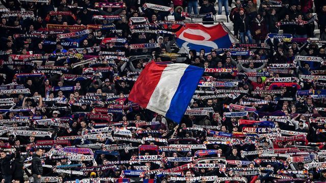 Lyon's supporters wave flags and hold banners during the French Cup semi-final football match between Olympique Lyonnais (OL) and Paris Saint-Germain (PSG) at the Groupama Stadium in Decines-Charpieu, centraleastern France, on March 4, 2020.