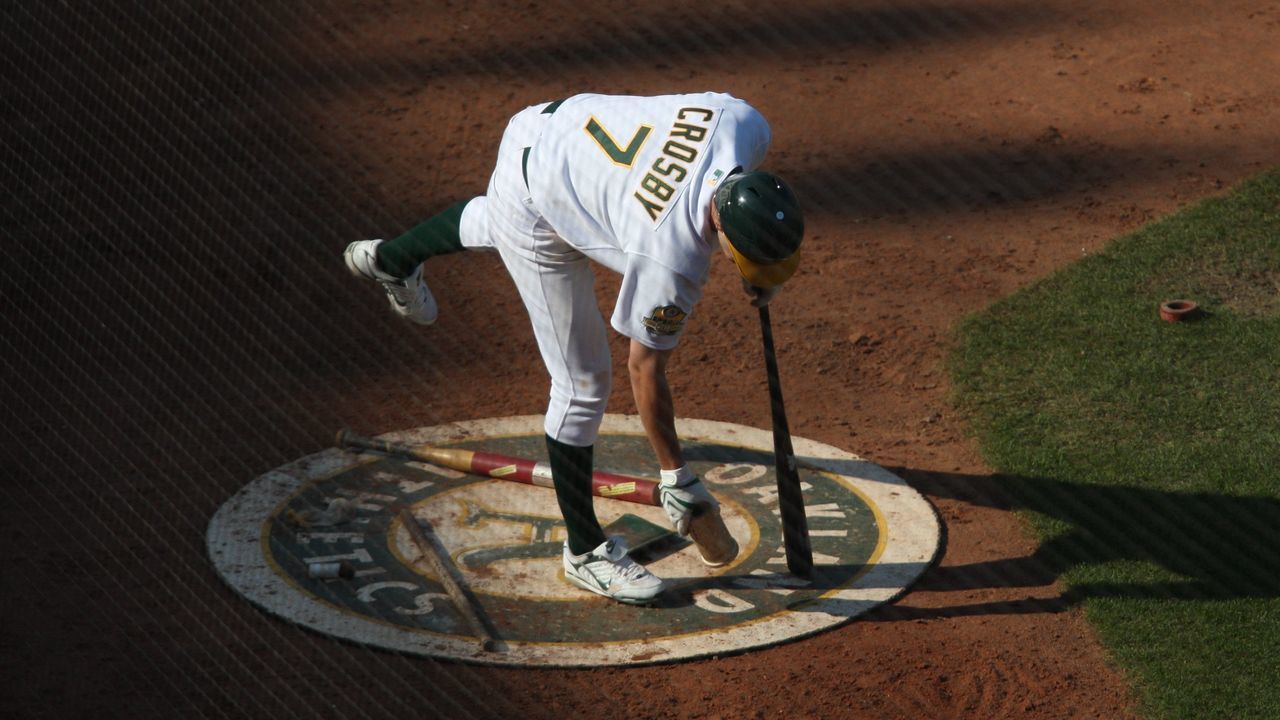 OAKLAND, CA - SEPTEMBER 14: Bobby Crosby of the Oakland Athletics grabs a weight in the on deck circle during the game against the Texas Rangers at the McAfee Coliseum in Oakland, California on September 14, 2008. The Athletics defeated the Rangers 7-4.