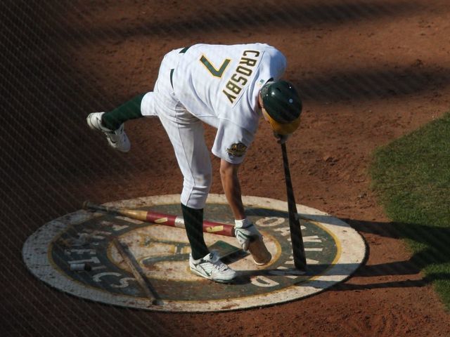 OAKLAND, CA - SEPTEMBER 14: Bobby Crosby of the Oakland Athletics grabs a weight in the on deck circle during the game against the Texas Rangers at the McAfee Coliseum in Oakland, California on September 14, 2008. The Athletics defeated the Rangers 7-4.