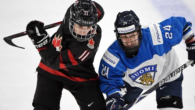 Jillian Saulnier (L) of Canada and Noora Tulus of Finland vie during the IIHF Women's Ice Hockey World Championships semifinal match between Canada and Finland in Espoo, Finland, on April 13, 2019.