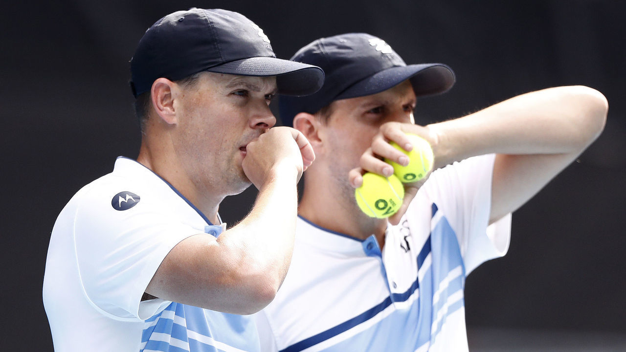 MELBOURNE, AUSTRALIA - JANUARY 27: Mike Bryan and Bob Bryan of the United States talk tactics in their Men's Doubles third round match against Ivan Dodig of Croatia and Filip Polasek of Slovakia on day eight of the 2020 Australian Open at Melbourne Park on January 27, 2020 in Melbourne, Australia.