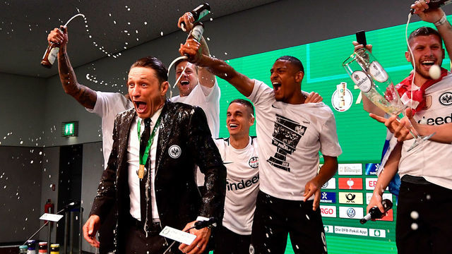 TOPSHOT - Frankfurt's Croatian head coach Niko Kovac reacts after his players soak him in beer at the press conference after the German Cup DFB Pokal final football match FC Bayern Munich vs Eintracht Frankfurt at the Olympic Stadium in Berlin on May 19, 2018.