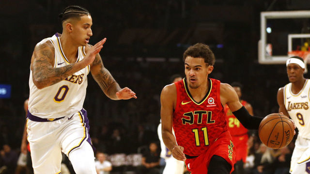 LOS ANGELES, CALIFORNIA - NOVEMBER 17: Trae Young #11 of the Atlanta Hawks moves the ball down the court as Kyle Kuzma #0 of the Los Angeles Lakers defends during the first half of a game at Staples Center on November 17, 2019 in Los Angeles, California.